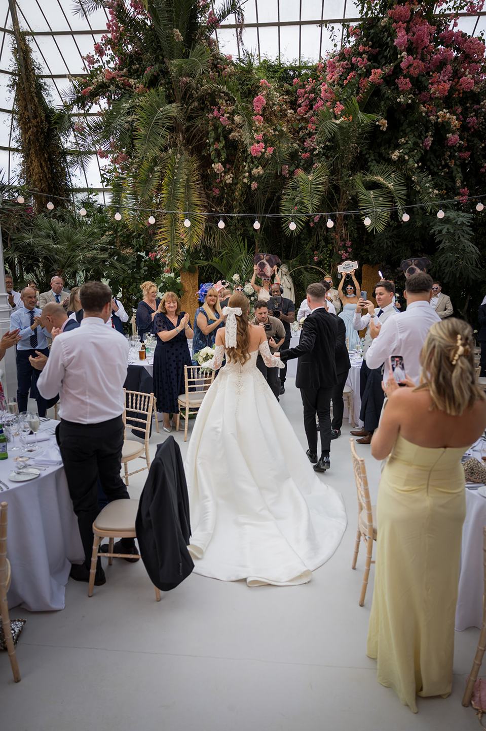 Guests celebrating indoors at Heather and Charlie’s Sefton Park Palm House wedding