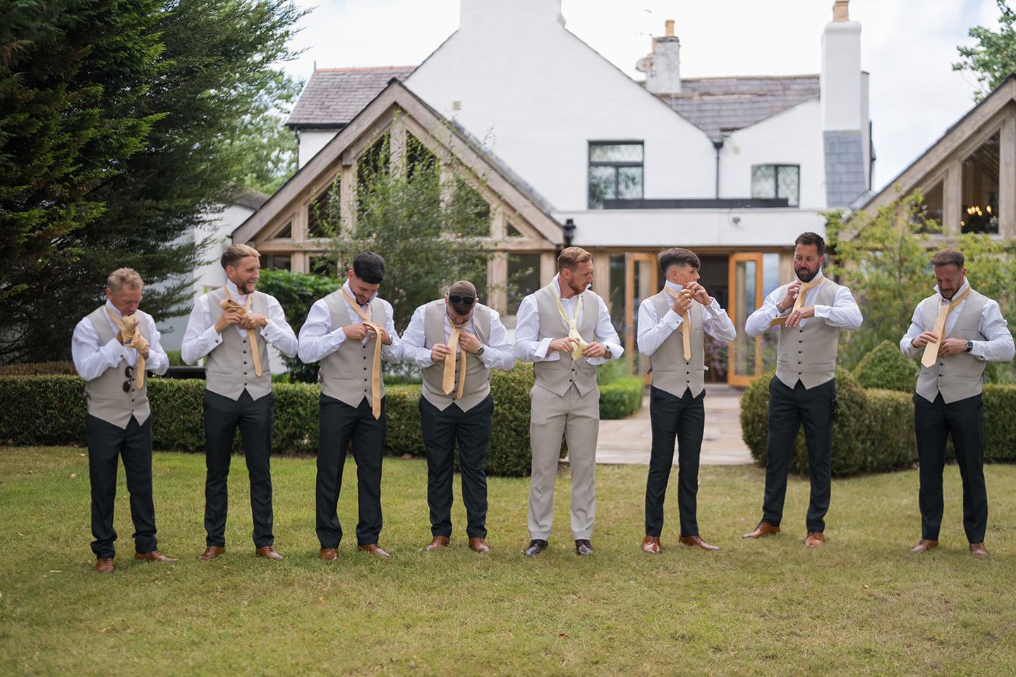 Groomsmen outside the venue at Lauren and Ryan’s The River Barn wedding