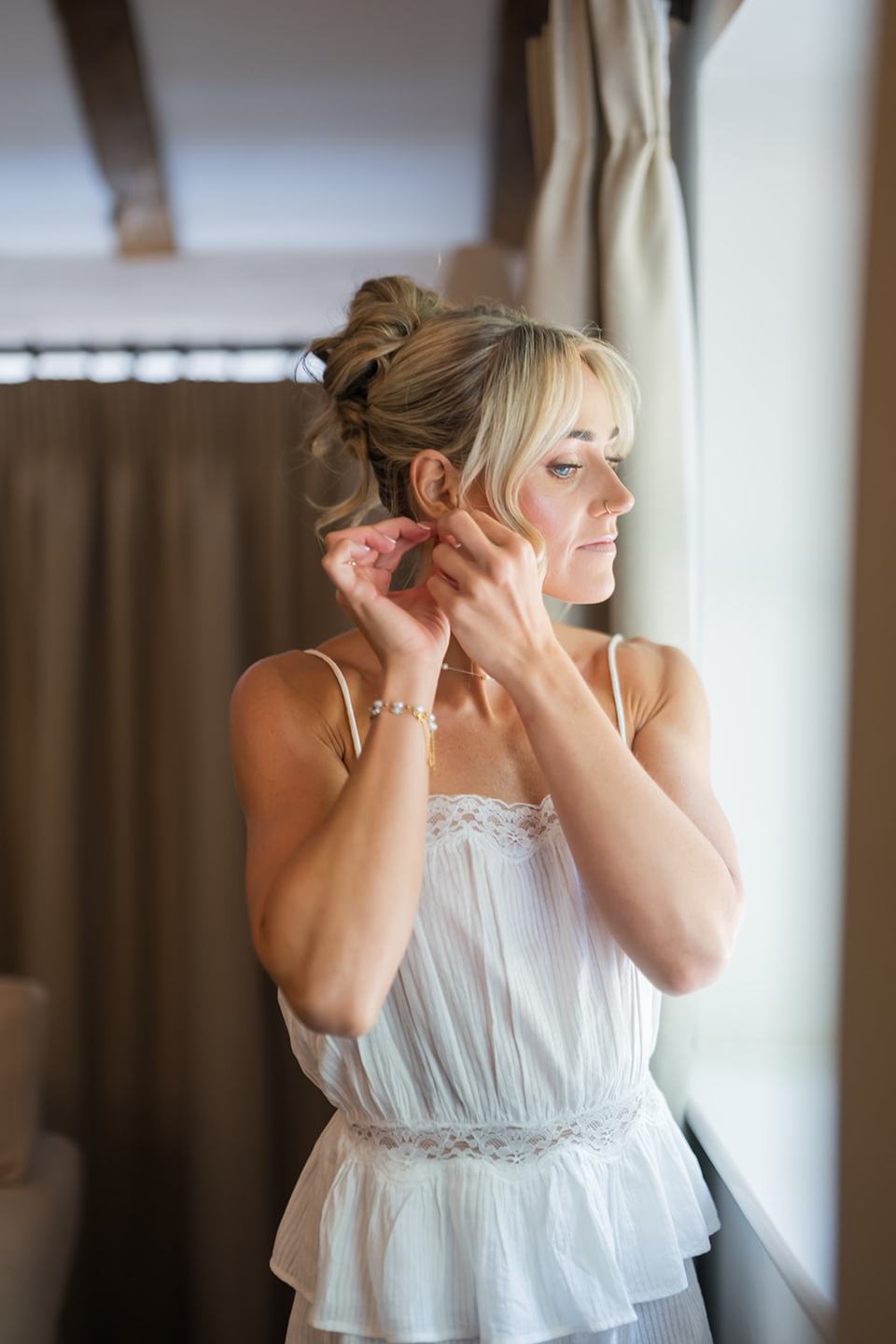 Bridal portrait by the window at Lauren and Ryan’s The River Barn wedding