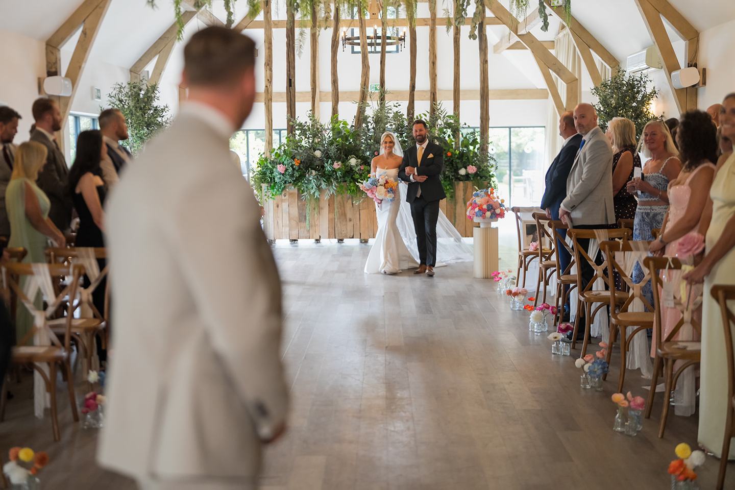 Walking down the aisle at Lauren and Ryan’s The River Barn wedding