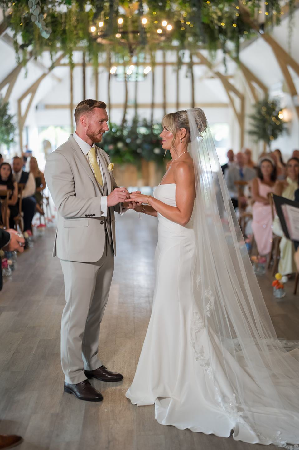 Exchanging rings at Lauren and Ryan’s The River Barn wedding