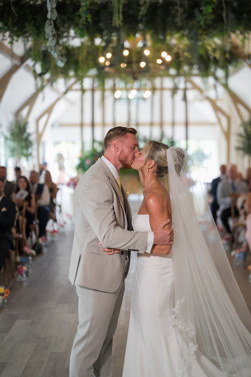 The first kiss at Lauren and Ryan’s The River Barn wedding