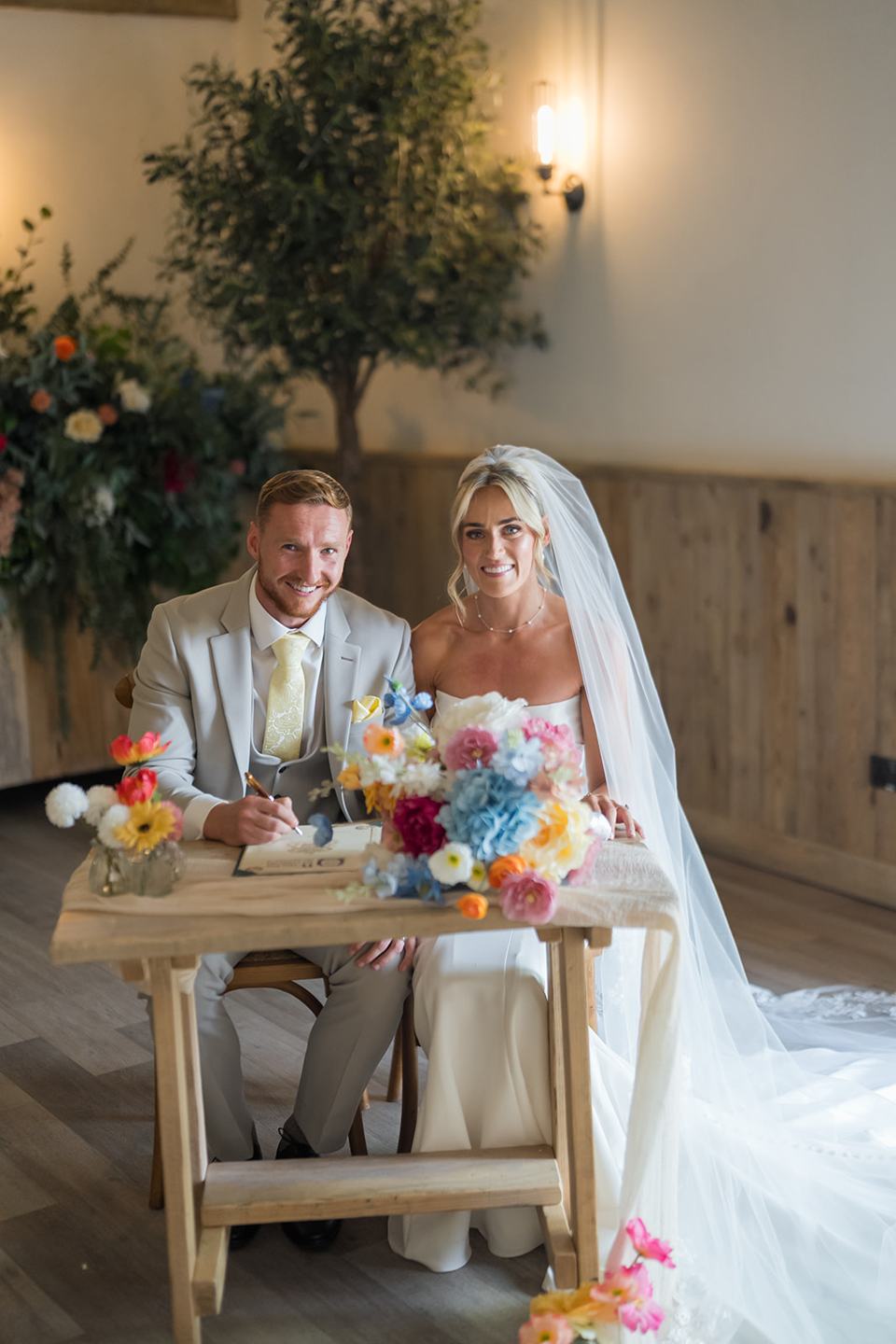 Signing the register at Lauren and Ryan’s The River Barn wedding