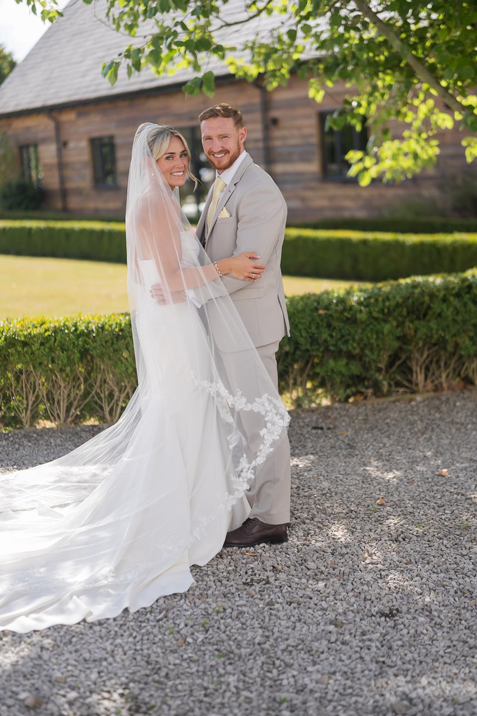 Portrait beside the barn at Lauren and Ryan’s The River Barn wedding