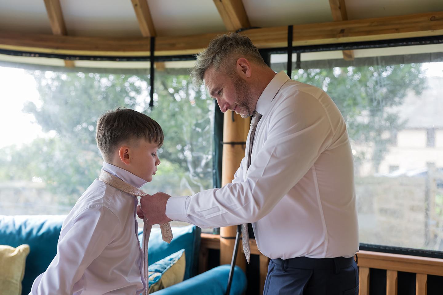 Groom helping a young guest at Rachel and Sean’s West Tower wedding