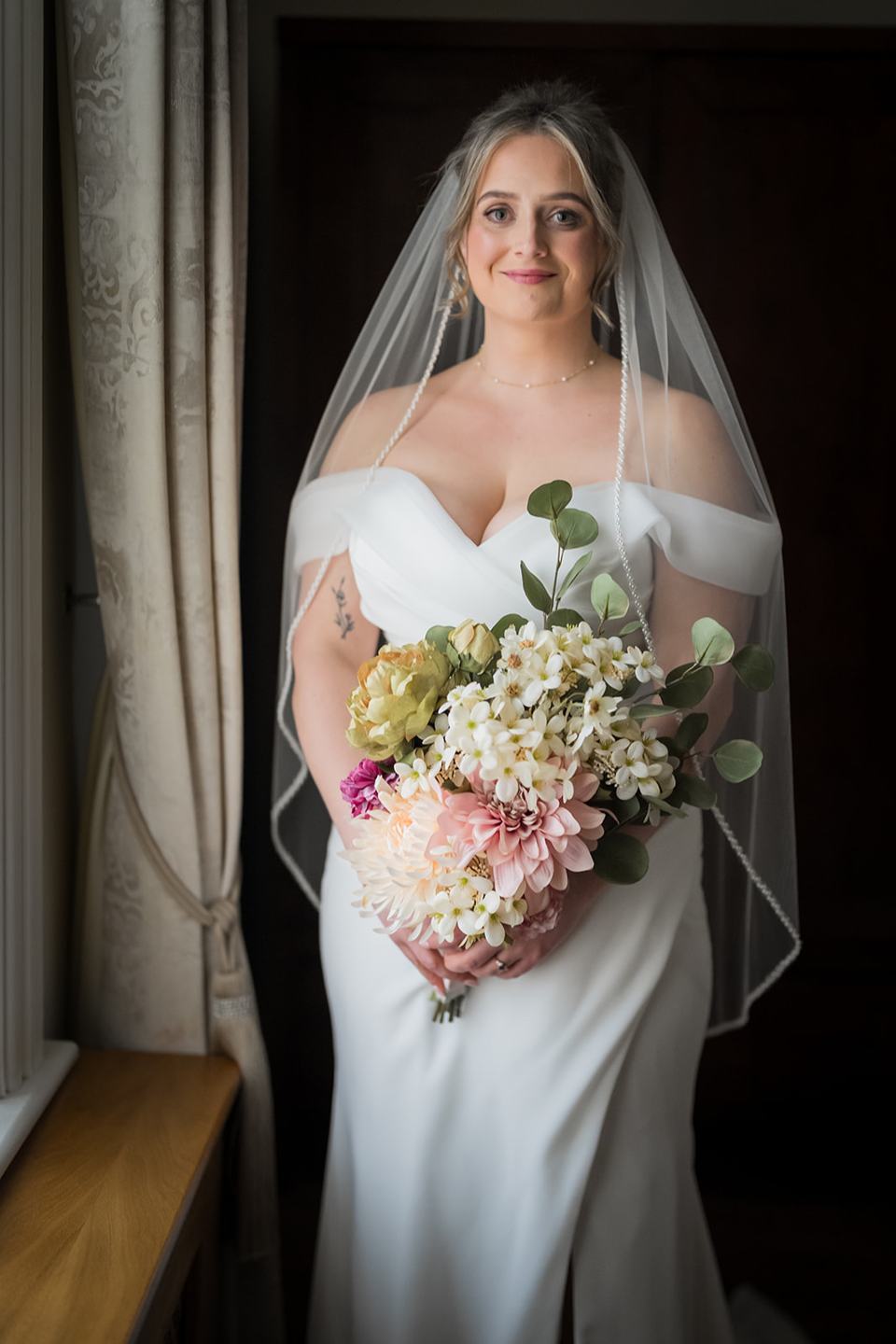 Bride beside the window at Rachel and Sean’s West Tower wedding