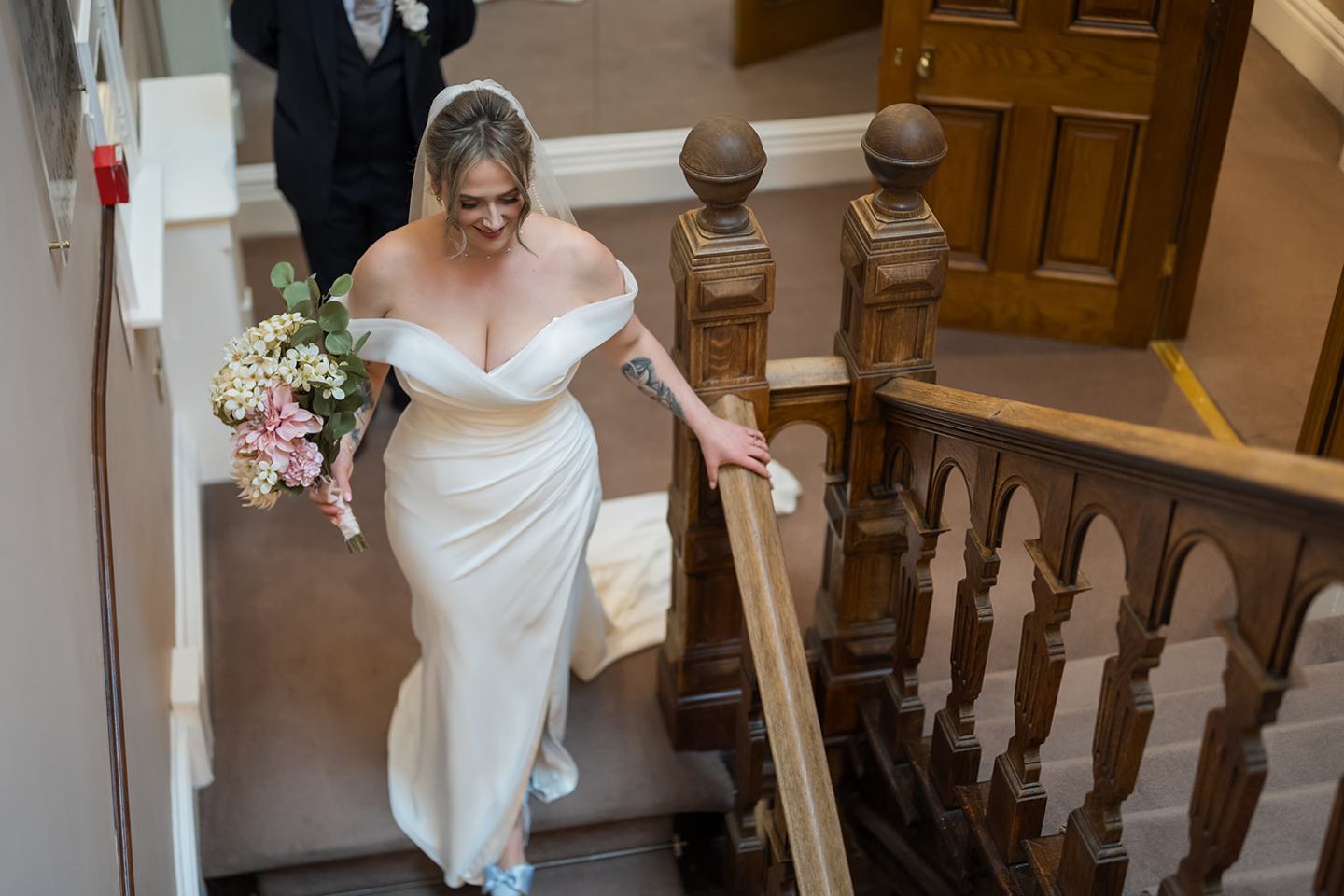 Bride descending the staircase at Rachel and Sean’s West Tower wedding