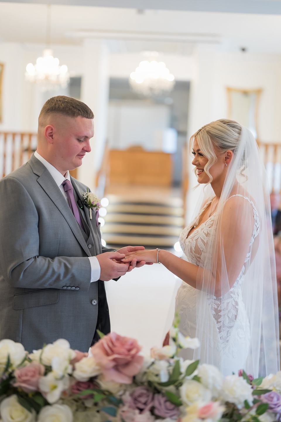 Exchanging wedding rings at Samantha and Adam’s West Tower wedding