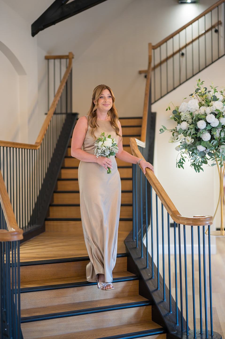 Bride on the staircase at Danielle and Joe’s The Whistle Barns wedding