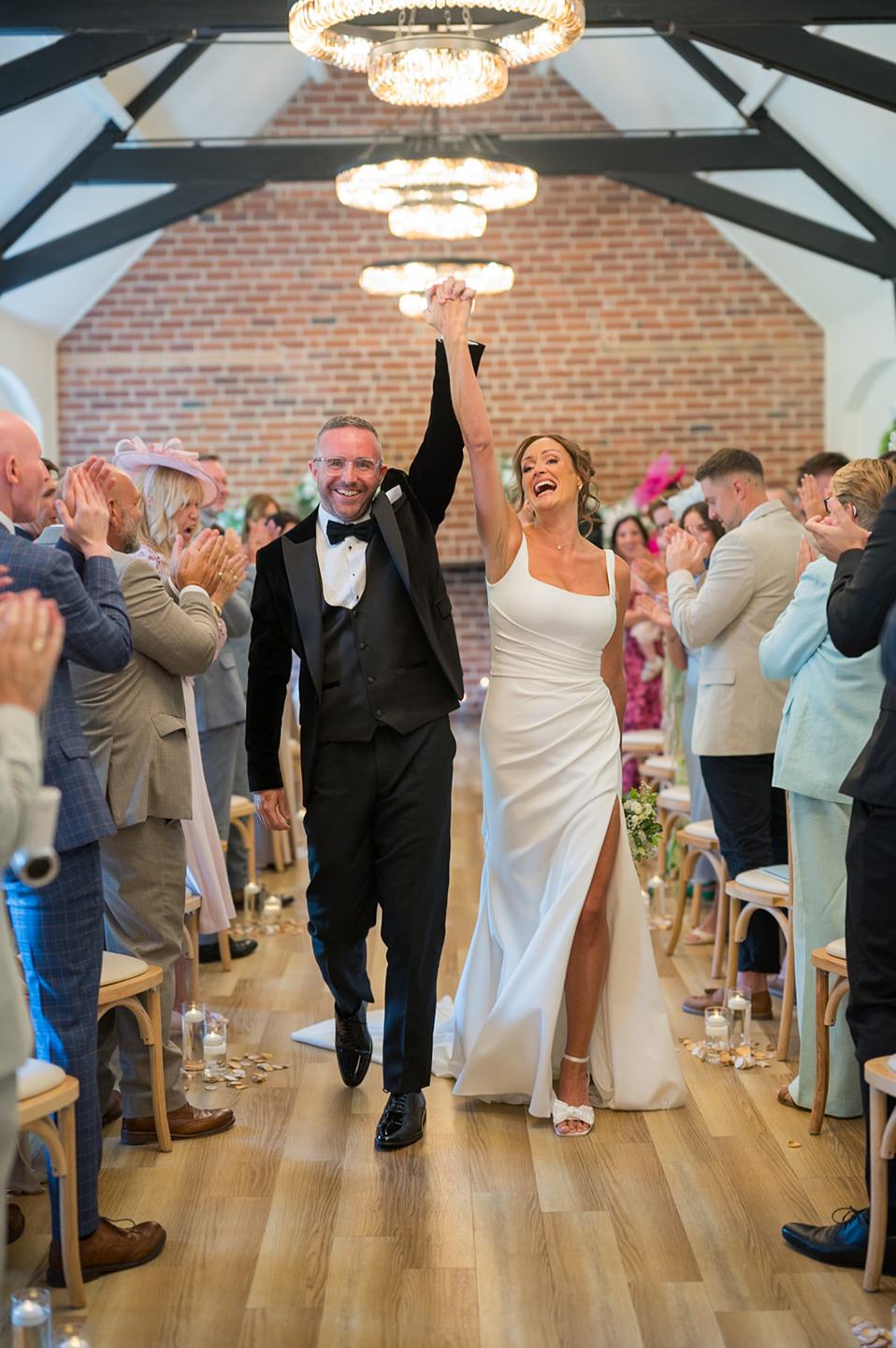 Walking out together at Danielle and Joe’s The Whistle Barns wedding