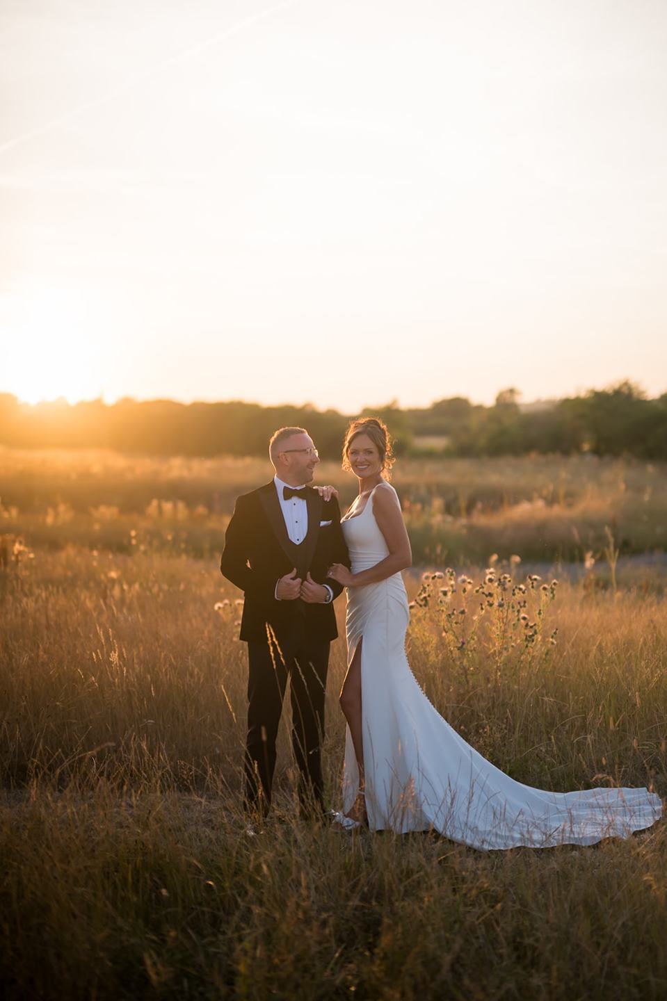 Walking in golden evening light at Danielle and Joe’s The Whistle Barns wedding