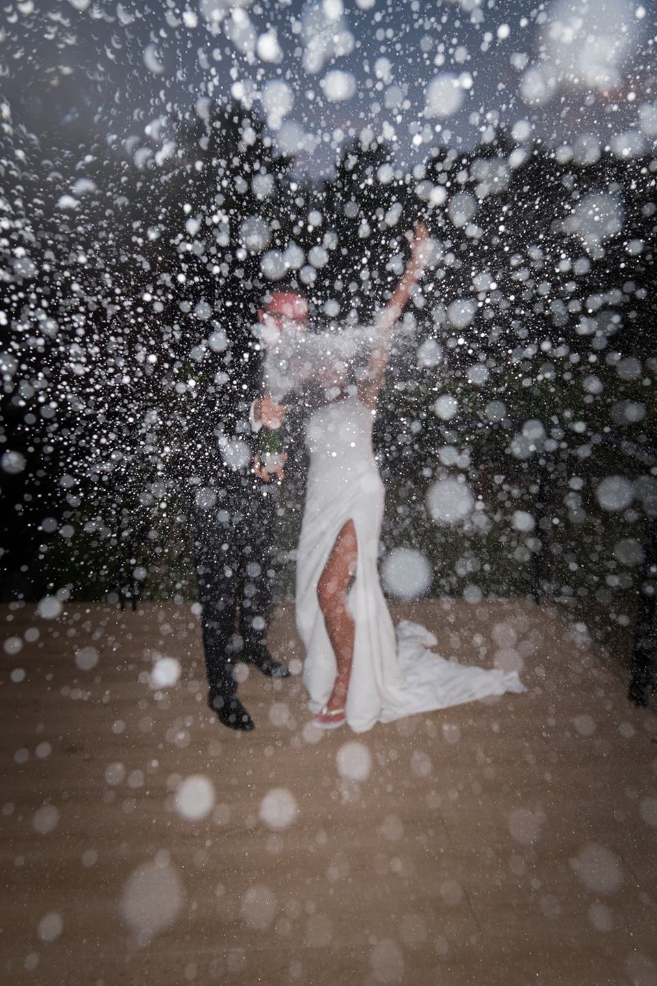 Celebrating with a spray of champagne at Danielle and Joe’s The Whistle Barns wedding