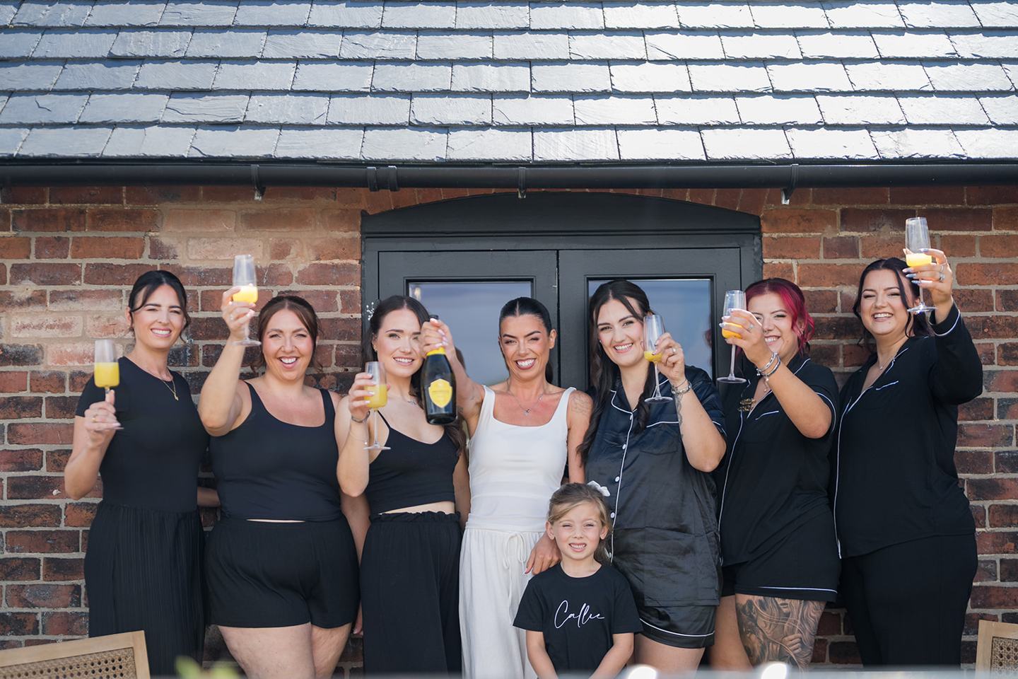 Bridesmaids outside the barn at Ellie and Thomas’s The Whistle Barns wedding