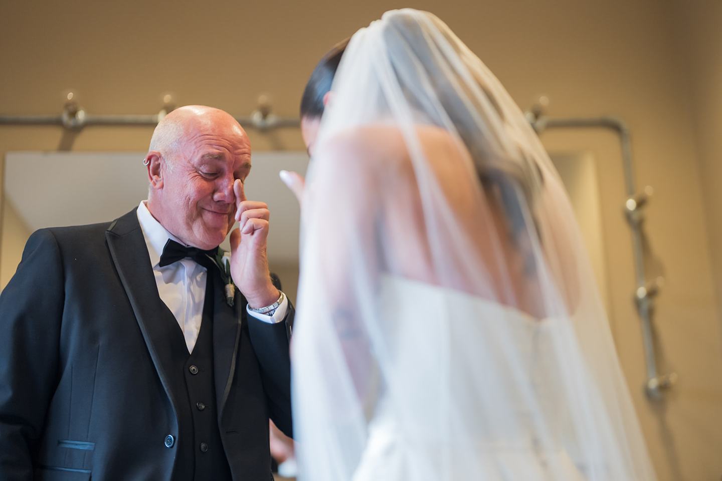 Bride sharing a first look with her father at Ellie and Thomas’s The Whistle Barns wedding