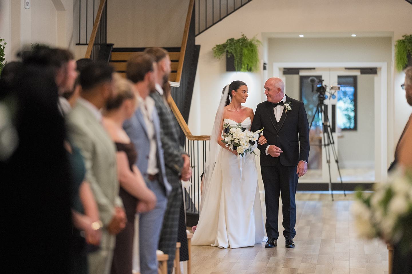 Bride arriving for the ceremony at Ellie and Thomas’s The Whistle Barns wedding