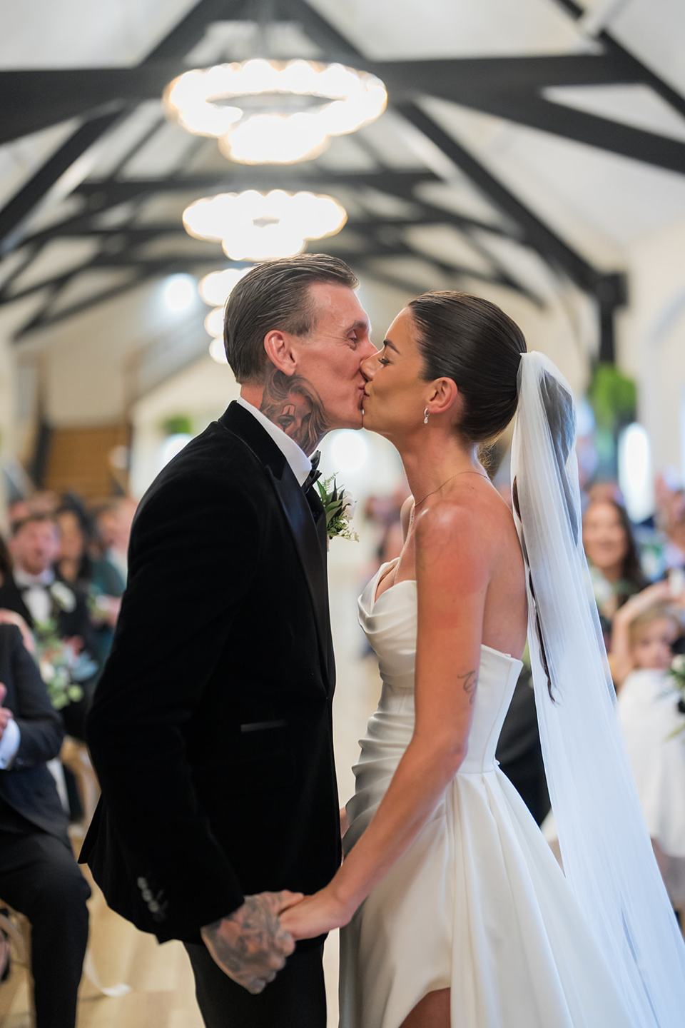 Newlyweds kissing after their vows at Ellie and Thomas’s The Whistle Barns wedding