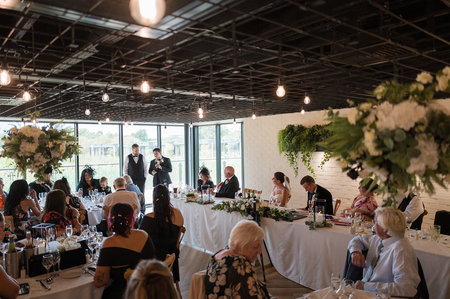 Guests gathered for the wedding breakfast at Ellie and Thomas’s The Whistle Barns wedding