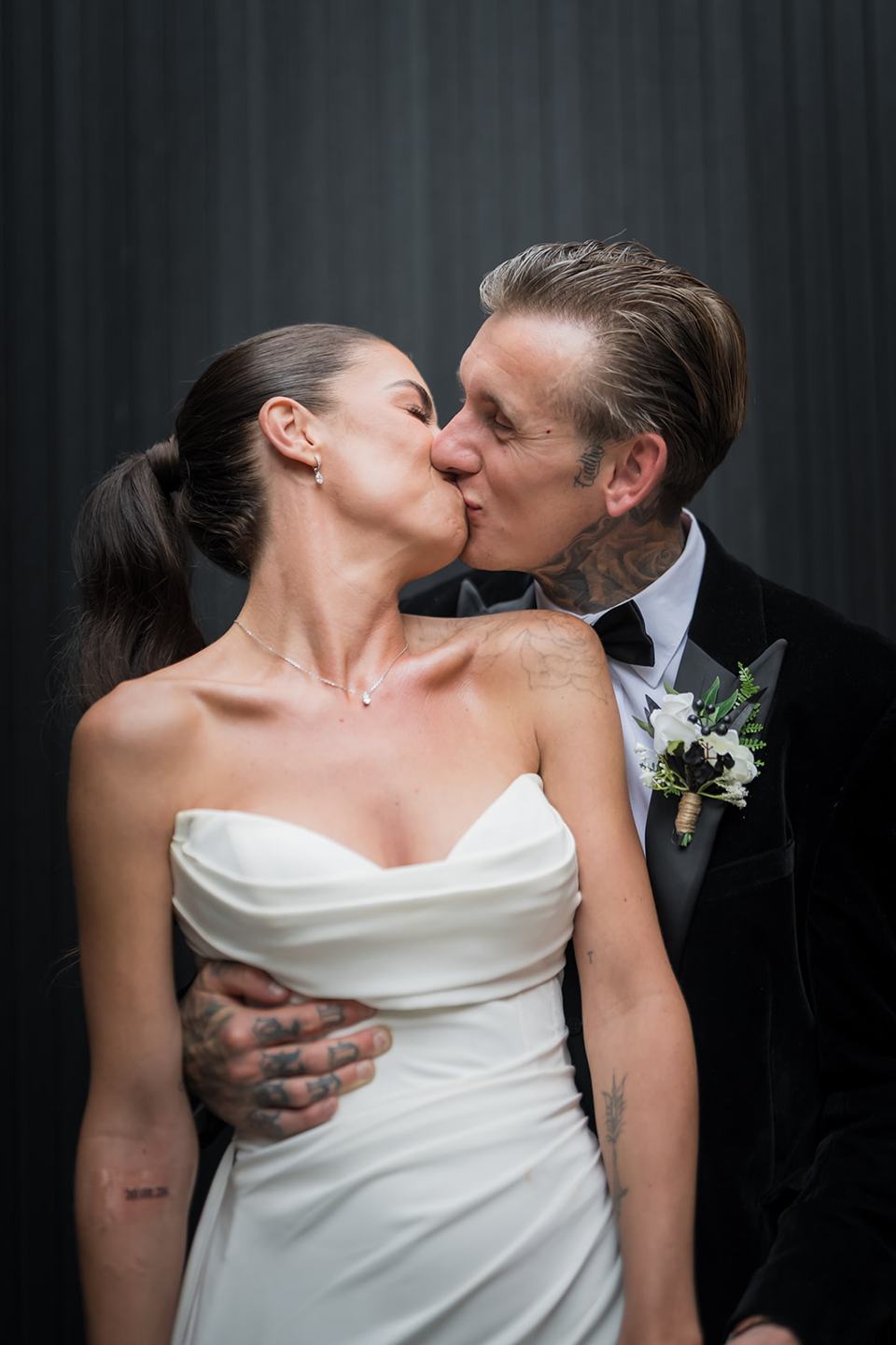 Newlywed portrait against the barn wall at Ellie and Thomas’s The Whistle Barns wedding