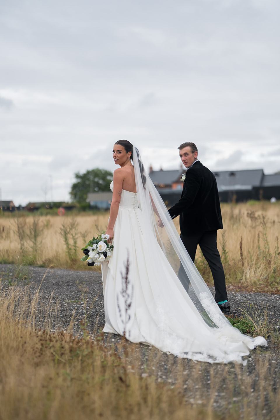 Couple beside the water at Ellie and Thomas’s The Whistle Barns wedding