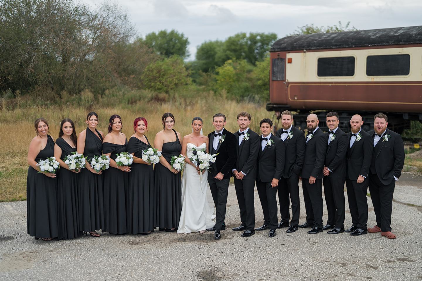 Wedding party outside at Ellie and Thomas’s The Whistle Barns wedding
