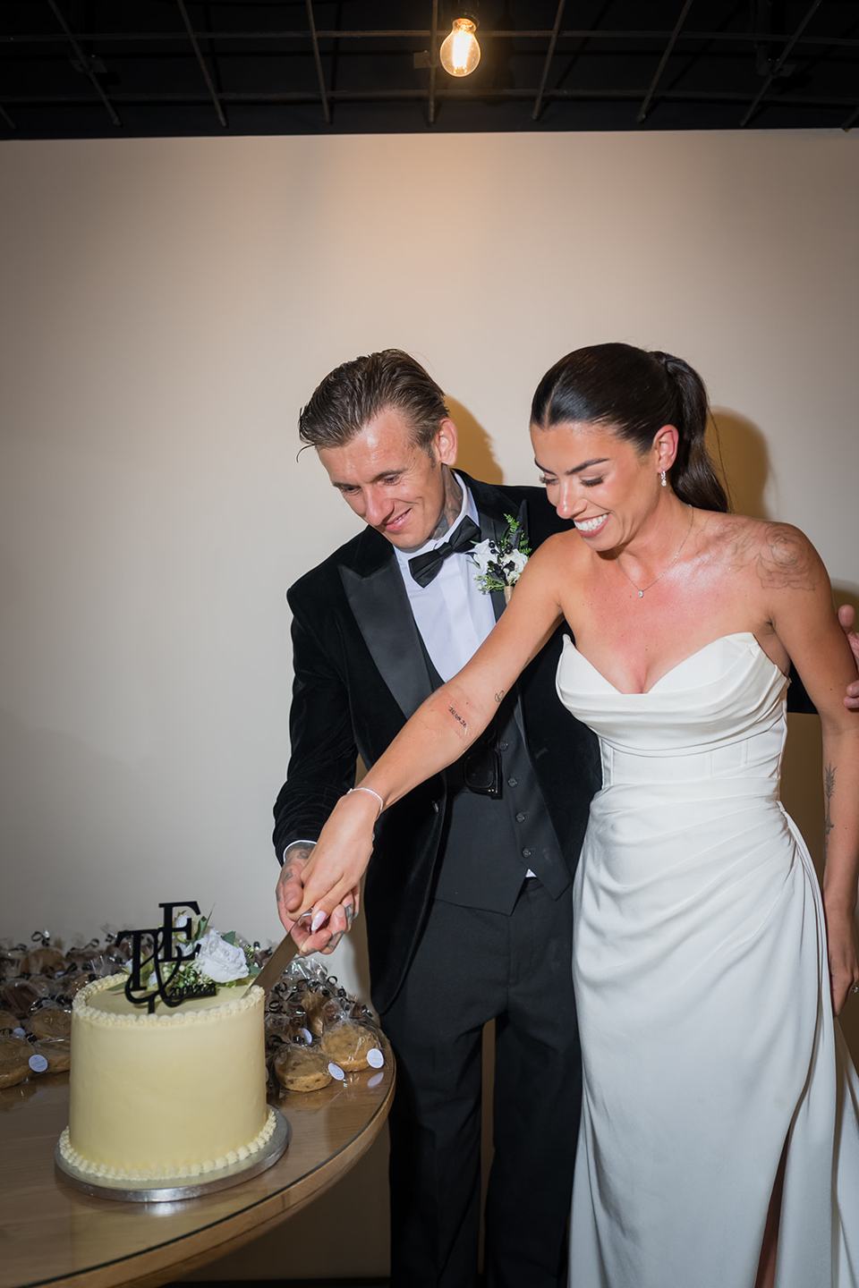 Cutting the wedding cake at Ellie and Thomas’s The Whistle Barns wedding
