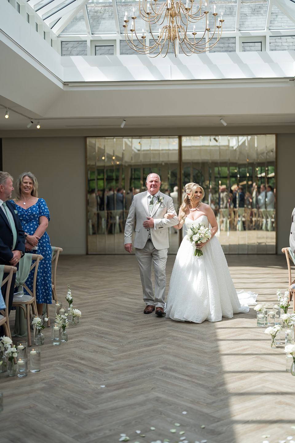 Bride walking down the aisle at Chloe and James’s Woodlands Hotel wedding