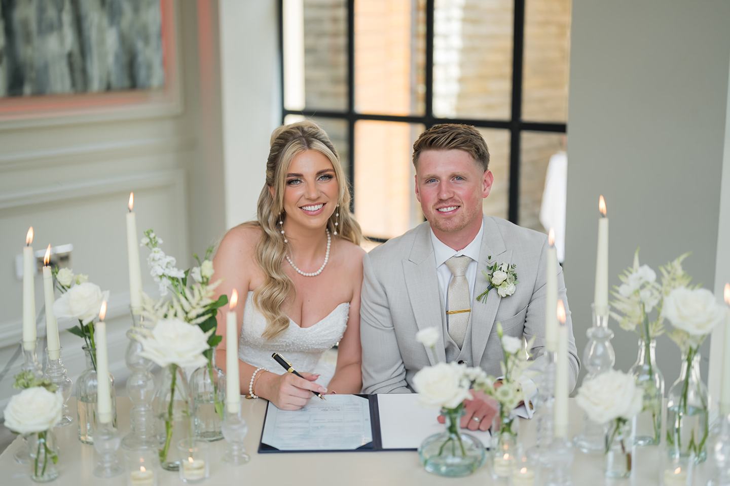 Signing the register at Chloe and James’s Woodlands Hotel wedding
