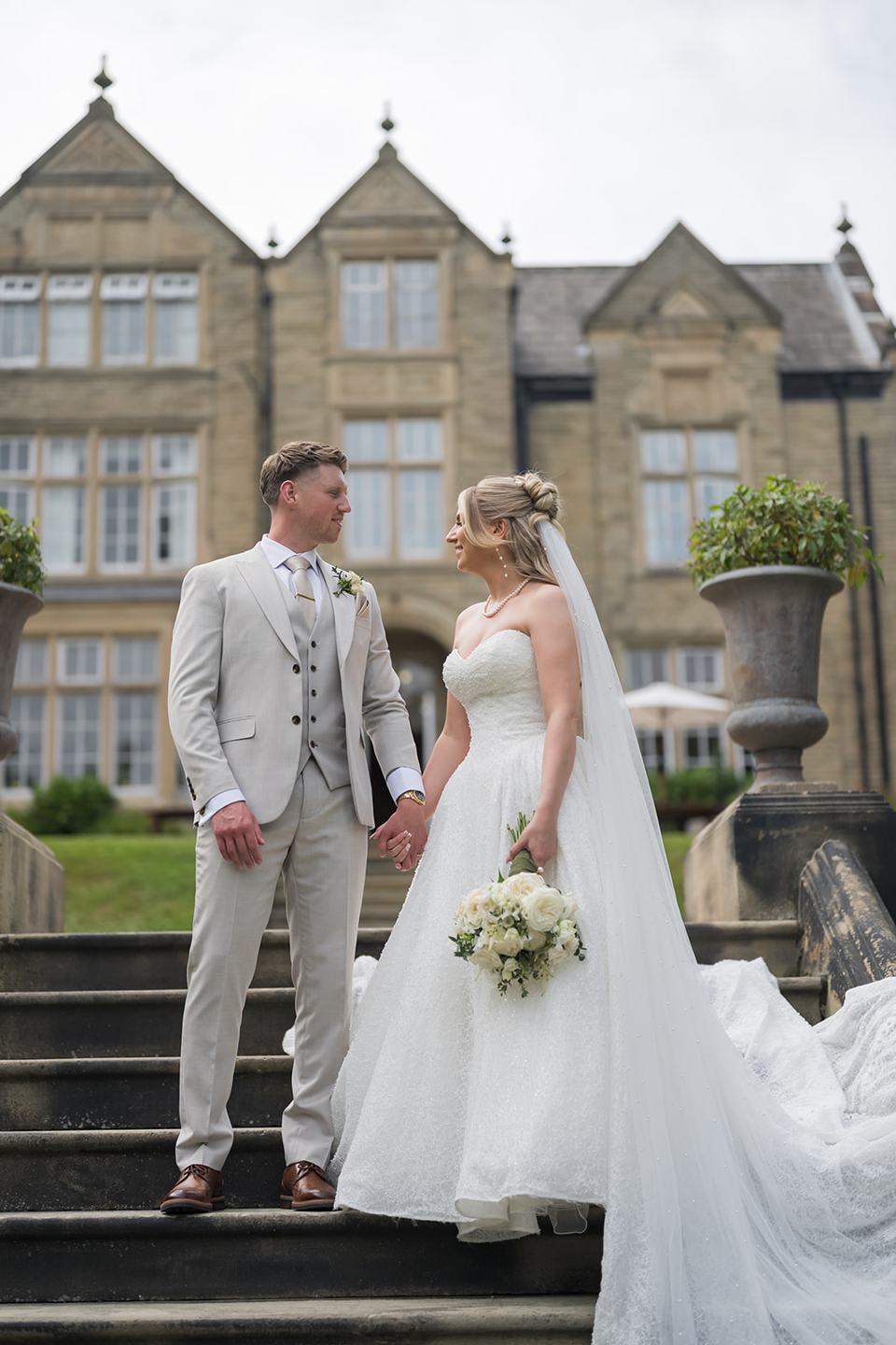 Couple on the stone steps at Chloe and James’s Woodlands Hotel wedding