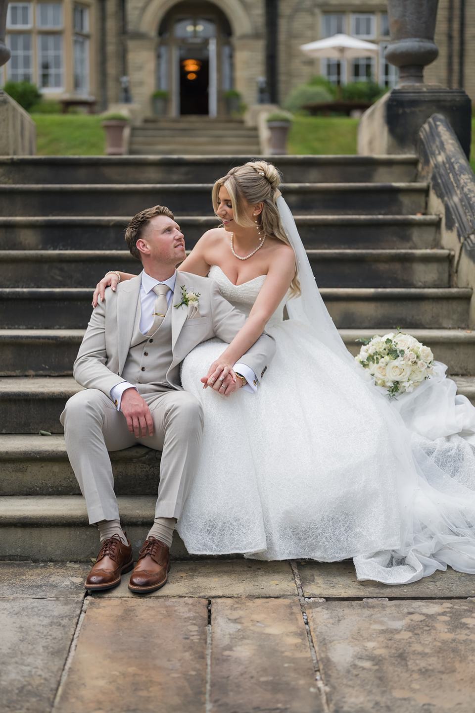 Relaxed portrait on the steps at Chloe and James’s Woodlands Hotel wedding